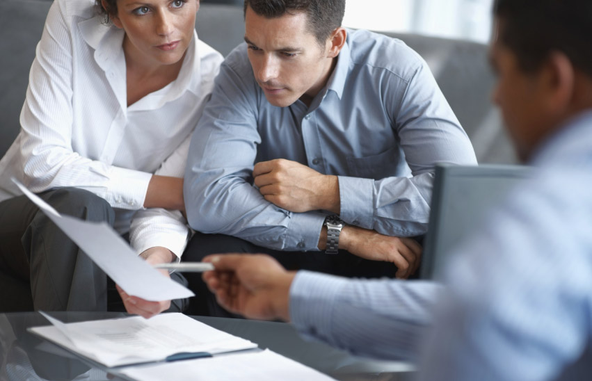 Young couple reviewing papers