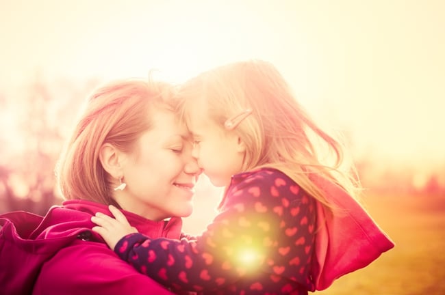 Child kissing mom