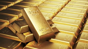 Gold bars stacked in rows showcase immense wealth in a secure vault environment.