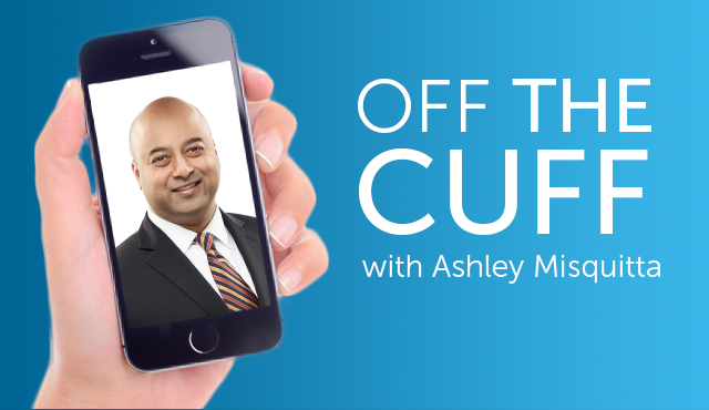 A hand holding a smartphone containing a close-up photo of a businessman next to the text “Off the cuff with Ashley Misquitta”
