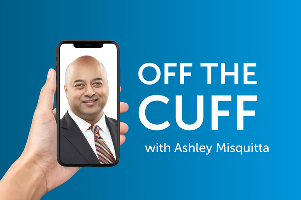 A hand holding a smartphone containing a close-up photo of a businessman next to the text “Off the cuff with Ashley Misquitta”